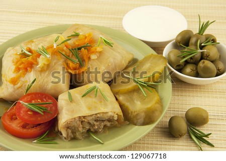 cabbage rolls  with tomatoes and cucumbers in ceramic plate
