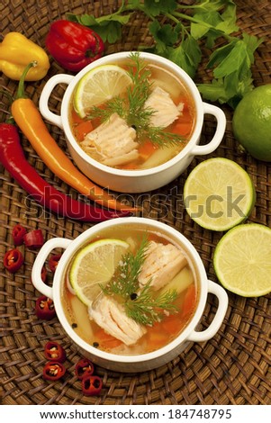 Bowls with salmon soup and veggies