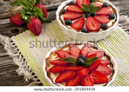 Sweet basket with cream and strawberries and blueberry