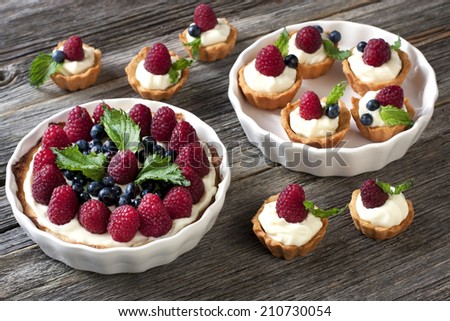 Sweet basket with cream and raspberries and blueberry