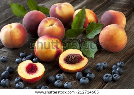 Ripe peaches sliced on a wooden table