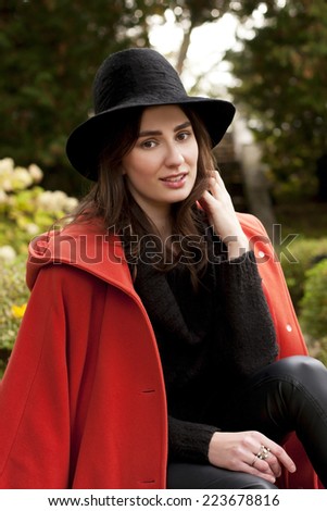 Beautiful young woman  in hat and coat