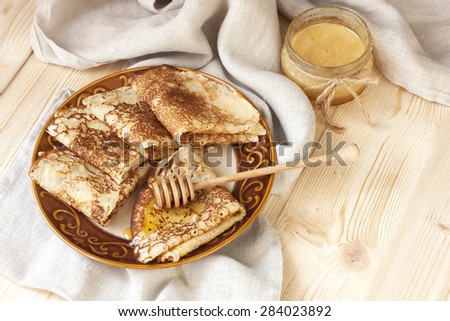 Breakfast of pancakes on  ceramic plate. Pancakes drenched with honey