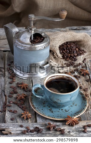 Fresh coffee bean in coffee bean grinder on wooden  background