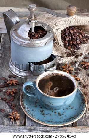Fresh coffee bean in coffee bean grinder on wooden  background