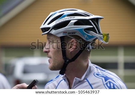 STILLWATER, MINNESOTA - JUNE 17: Reporter interviews pro cyclist Christian Helmig following victory at final stage of Nature Valley Grand Prix at Criterium on June 17, 2012 in Stillwater