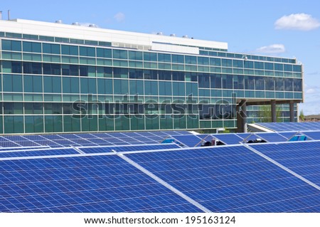 Ground level solar panel array in front of office building