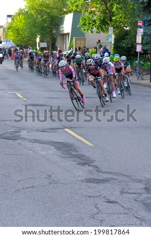 JUNE 13, 2014: Pro cyclists turn corner at stage four of 2014 North Star Grand Prix in Minneapolis, Minnesota. Nearly 300 top pro cyclists from around the world compete in this prestigious event.