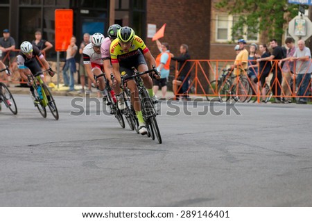 MINNEAPOLIS, MN/USA - JUNE 19, 2015: Pro cyclists lead pack at Uptown Criterium or stage four of prestigious 2015 North Star Grand Prix pro cycling event in Minneapolis.