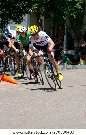STILLWATER, MN/USA - JUNE 21, 2015: Cyclists in peloton chase leaders at Stillwater Criterium or stage six of prestigious 2015 North Star Grand Prix pro cycling event in Stillwater.