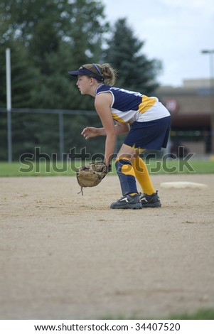 Girl in position at second base on softball field