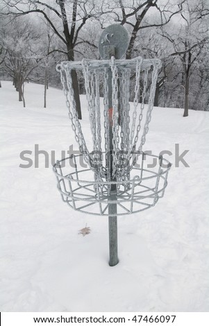 Disc golf scoring basket or pole hole on a snow covered course