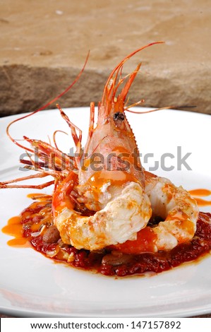 Jumbo shrimp beautifully plated over a bed of red beans.