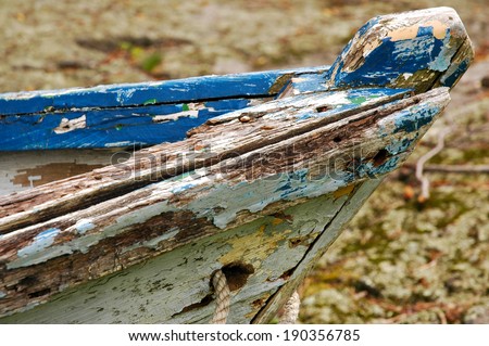 Profile shot of the bow of an old wood boat.