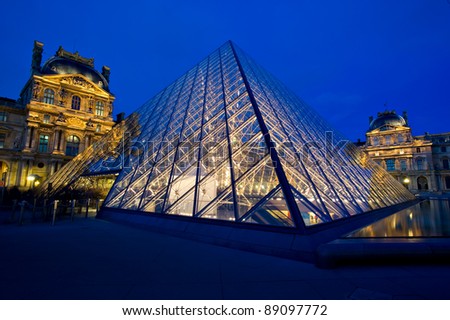 PARIS - MARCH 26: Louvre Pyramid shines at dusk on March 26, 2010 in Paris. Louvre is the biggest Museum in Paris displaying over 60,000 square meters of exhibition space.