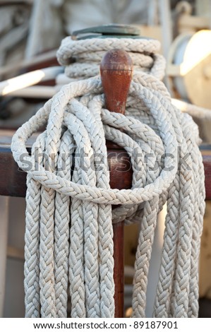 Ropes wrapped around a belaying pin.  Detail of a passenger cruise ship sailing in the Society Islands, Tahiti.