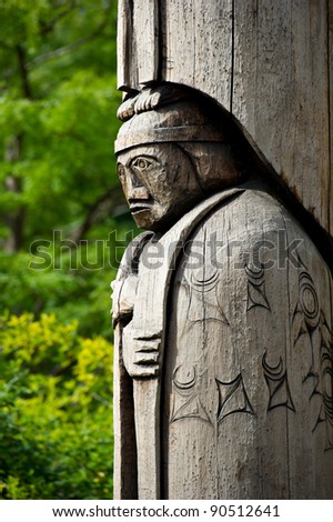 Detail of a totem pole located in Duncan, British Columbia. Wood carving representation of a person.