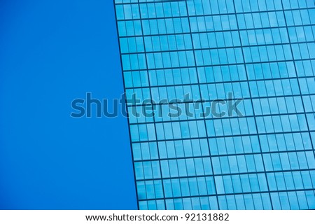 Looking up at a Modern Skyscraper building against the blue sky
