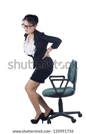 Business woman with backache after long work on chair. Isolated on white background, Model is Asian woman.