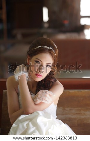Young Asian lady in white bride dress, Model is Thai Ethnicity