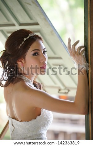 Young Asian lady in white bride dress, Model is Thai Ethnicity