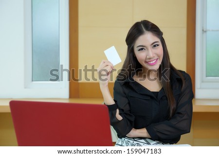 Young woman shopping on the Internet with credit card.