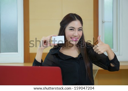 Young woman shopping on the Internet with credit card.