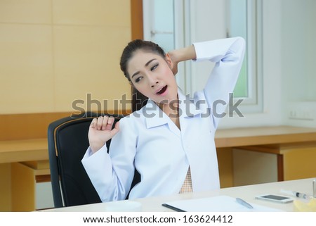 Tired female doctor stretching, Model is Asian woman.