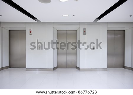 Three elevator doors in office building