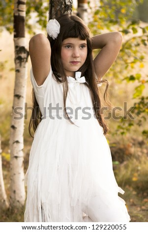 little girl in white dress on the country background