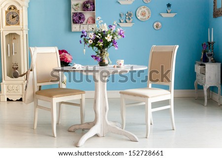 Dining Room Interior With Flowers Decorative Plates Blue Wall An
