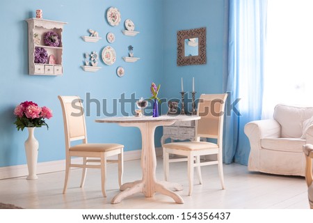 Dining Room Interior With Flowers Decorative Plates Blue Wall An
