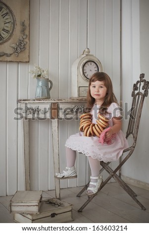 little girl with barankas in the shabby chic interior