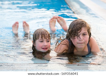 two blond sisters in the swimming pool