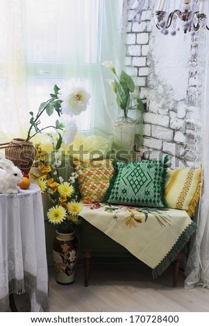 Living Room Interior Corner With Colored Pillows, Vases And Flowers