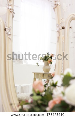 beautiful art composition with bouquet of roses and mirror