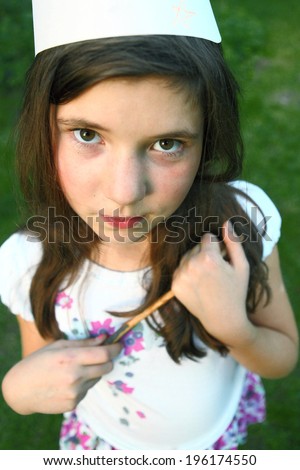 little preteen girl in the fairy image with cone hat and magic stick