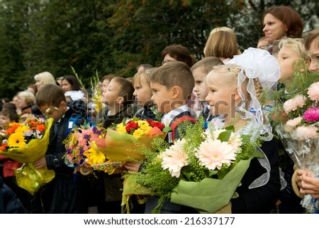 MOSCOW, SEPTEMBER 1, 2014: The first school day for the unidentified first grade kids on the September 1 2014. Solemn ceremonial meeting for the beginning of the school year.