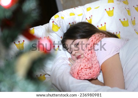 beautiful teen girl with long dark hair sick in bed in christmas eve