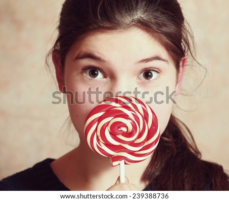 beautiful preteen girl with round candy and brown eyes