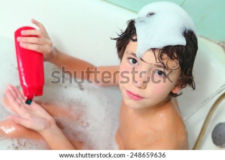 handsome preteen boy with shampoo take soap bath and wash his head