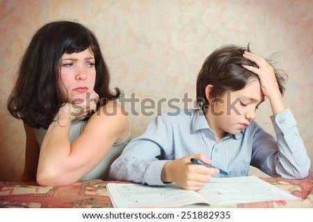 mother try to help her son to do difficult task exercise