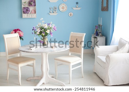dining room interior with flowers decorative plates blue wall an
