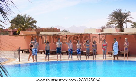 EGYPT, HURGHADA, MARCH 31, 2015: Animation team perform Olympic Games water polo in egyptian water park hotel beach resort, March 31, 2015.