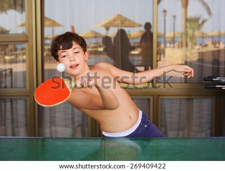 preteen handsome boy play table tennis in the beach resort hotel recreation area
