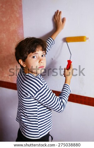 preteen handsome boy in frock with roll coaster and wallpaper