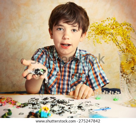 preteen handsome boy show  the result of his rainbow loom hobby panda