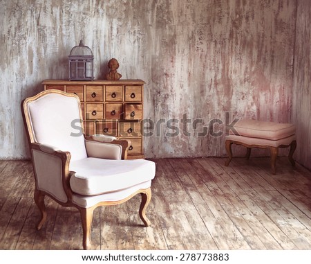 wooden chest of drawers in shabby styled room with bird cage and Mozart bust