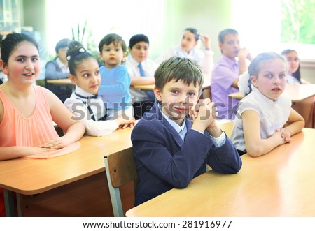 MOSCOW, MAY 26, 2015: Graduation in the primary school in Moscow, May 26. Graduating kids in the classroom  gets diploma and then go to the middle school.
