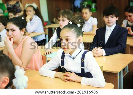 MOSCOW, MAY 26, 2015: Graduation in the primary school in Moscow, May 26. Graduating kids in the classroom  gets diploma and then go to the middle school.